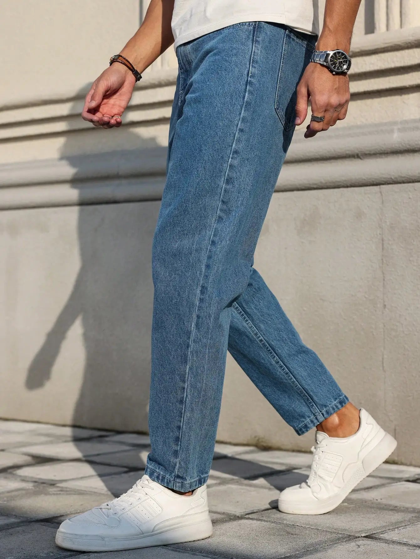 Men's jeans are made of classic blue denim fabric with a loose fit, making them an indispensable versatile item in the wardrobe. - trendingshoping.com