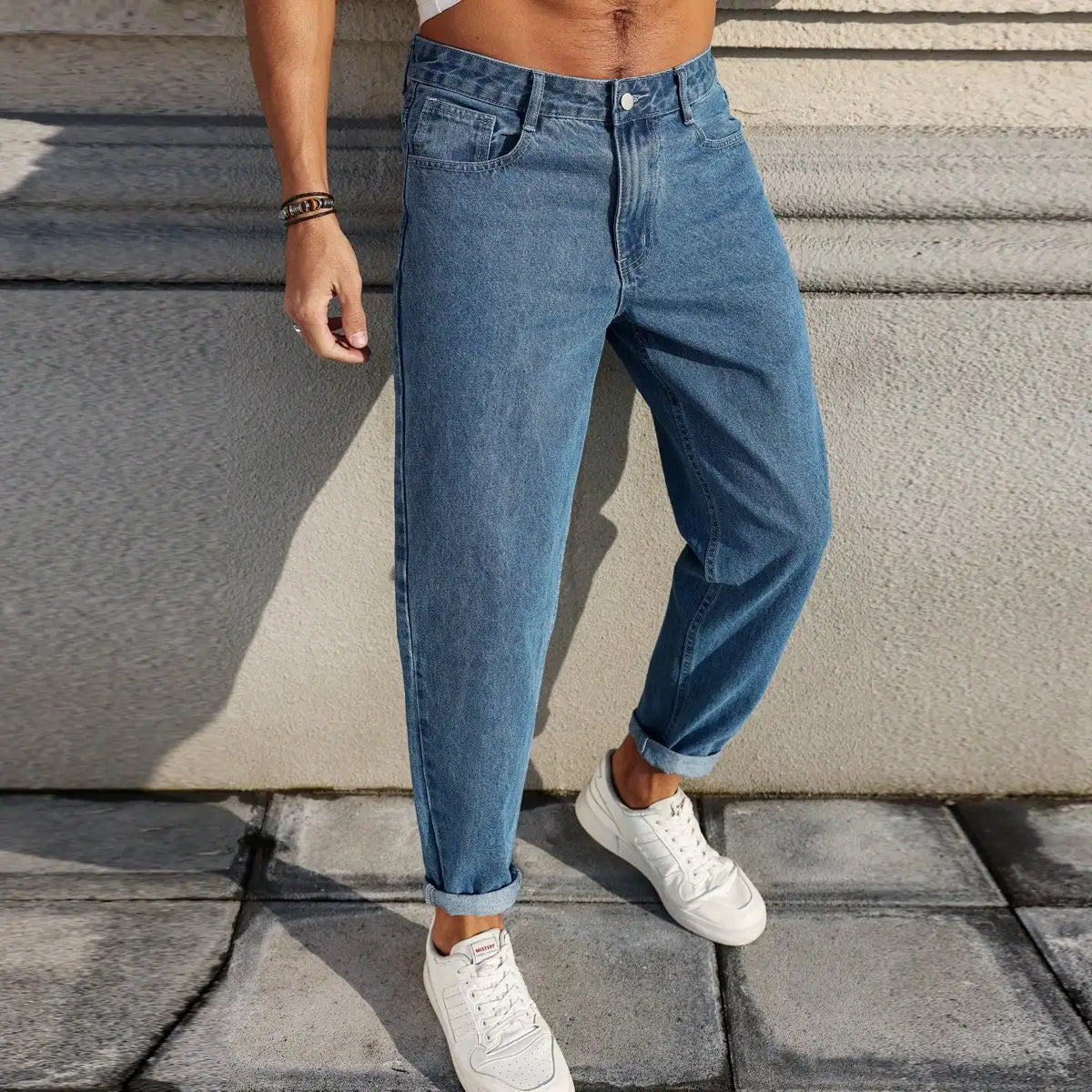 Men's jeans are made of classic blue denim fabric with a loose fit, making them an indispensable versatile item in the wardrobe. - trendingshoping.com