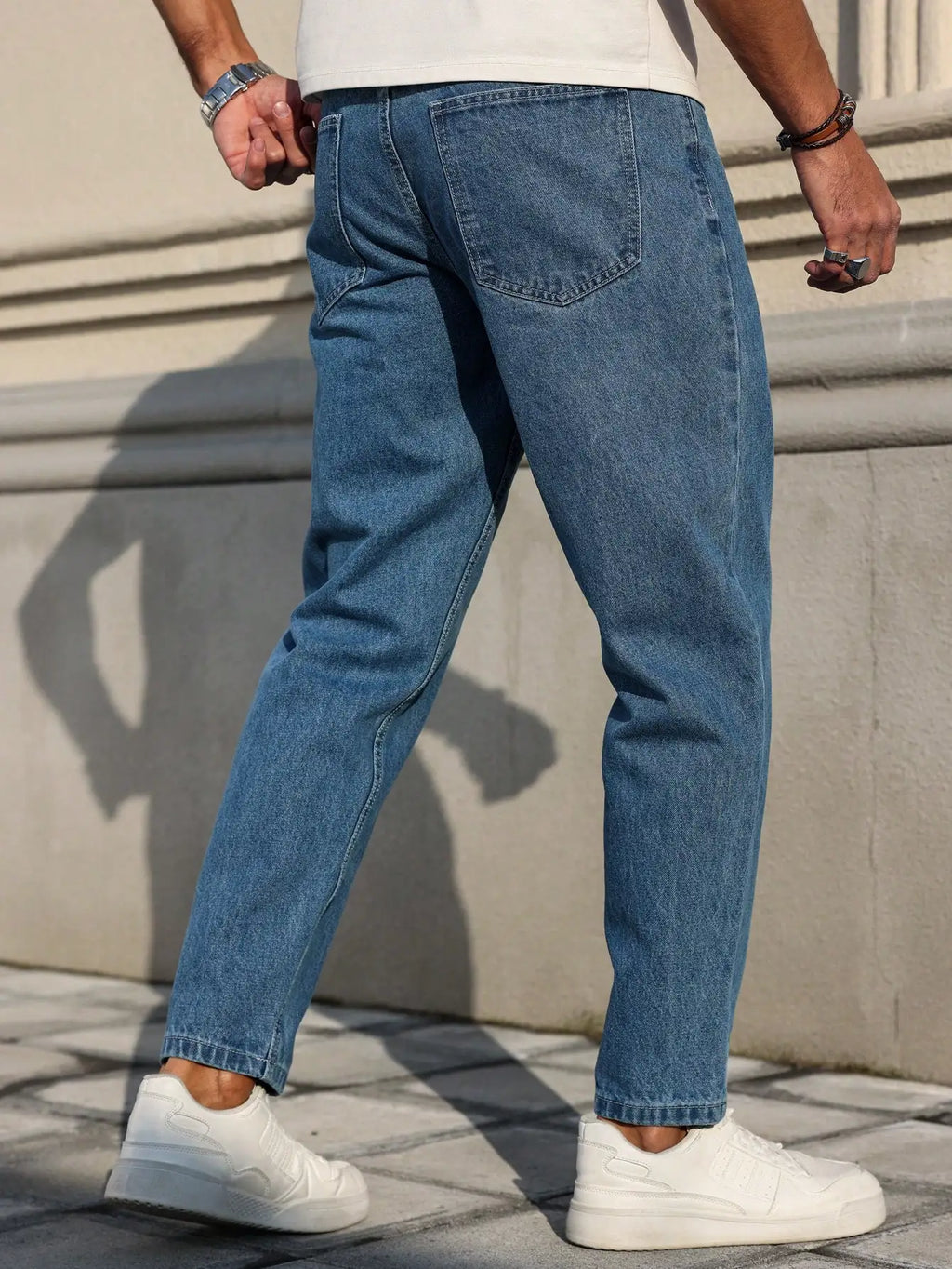 Men's jeans are made of classic blue denim fabric with a loose fit, making them an indispensable versatile item in the wardrobe. - trendingshoping.com