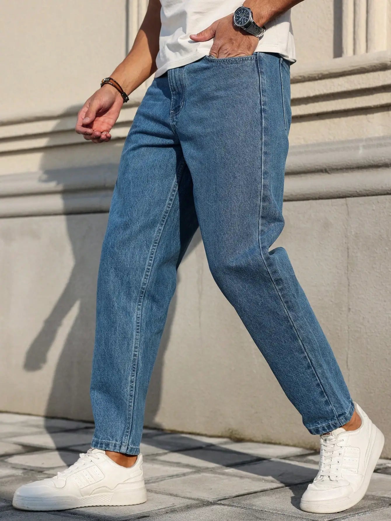 Men's jeans are made of classic blue denim fabric with a loose fit, making them an indispensable versatile item in the wardrobe. - trendingshoping.com