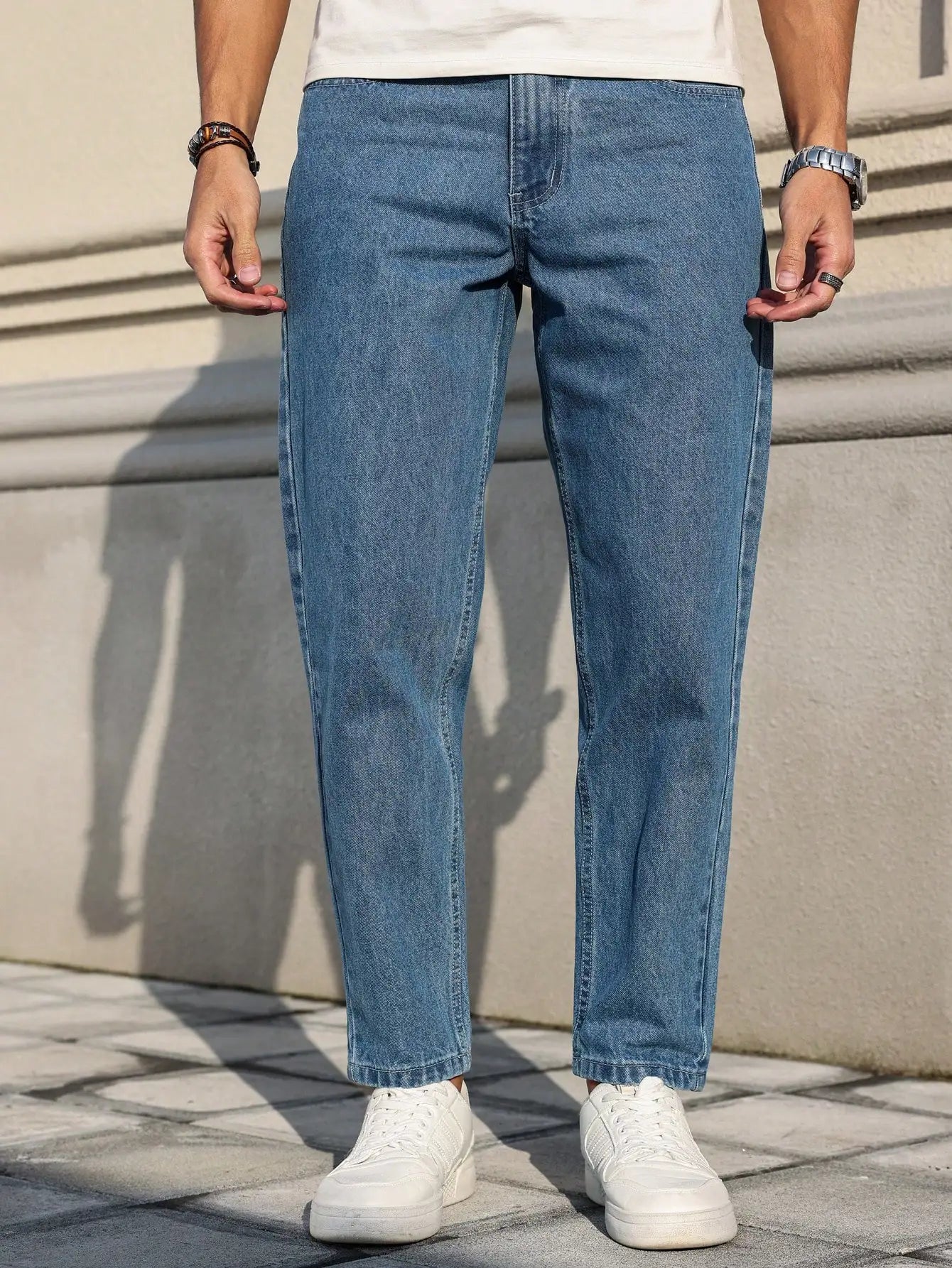 Men's jeans are made of classic blue denim fabric with a loose fit, making them an indispensable versatile item in the wardrobe. - trendingshoping.com