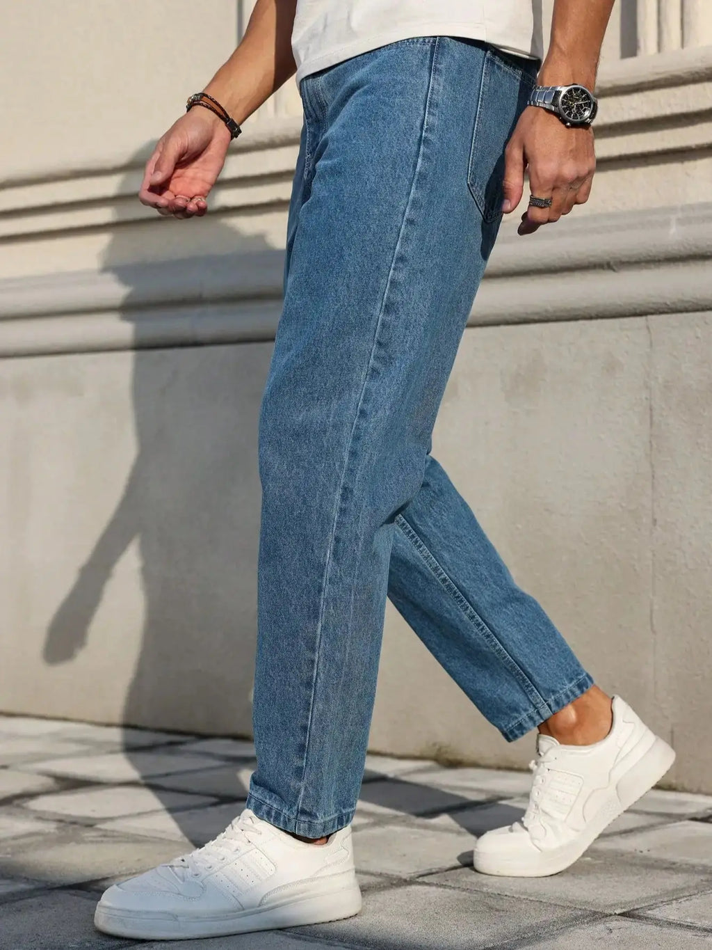 Men's jeans are made of classic blue denim fabric with a loose fit, making them an indispensable versatile item in the wardrobe. - trendingshoping.com