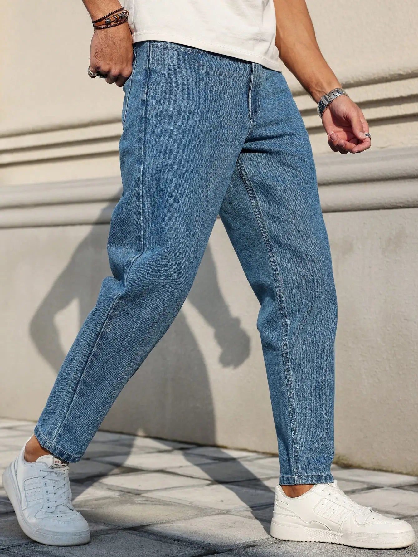 Men's jeans are made of classic blue denim fabric with a loose fit, making them an indispensable versatile item in the wardrobe. - trendingshoping.com