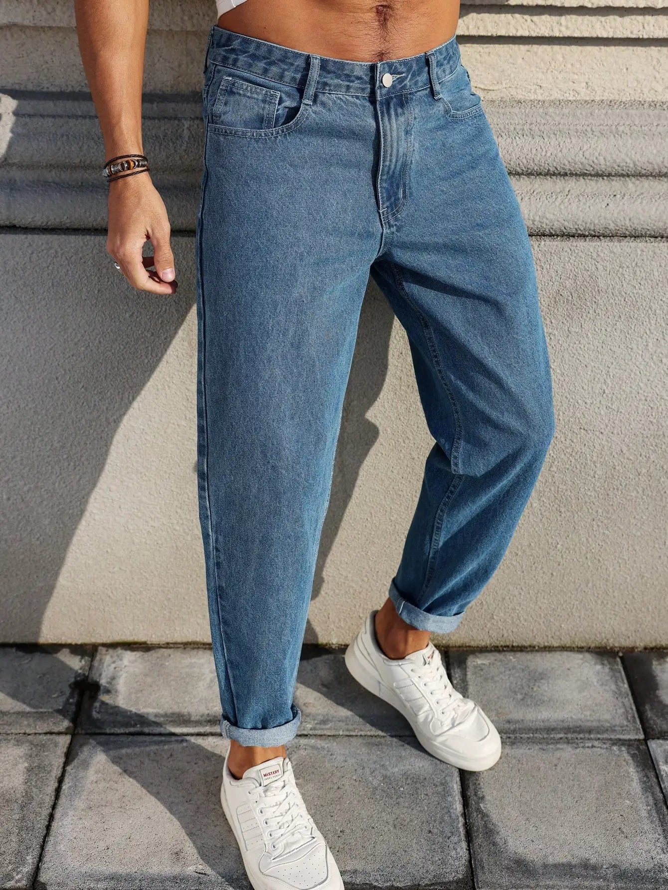 Men's jeans are made of classic blue denim fabric with a loose fit, making them an indispensable versatile item in the wardrobe. - trendingshoping.com